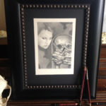 A graphite piece entitled Whisperer. An undead creature taking orders from his muse.