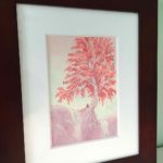 A romantic couple sitting under a tree.