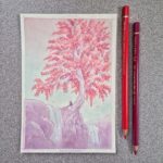 A romantic couple sitting under a tree.