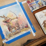 Casein painting by Chuck Grieb of a rabbit fairy teaching his son to shoot an arrow. On the drawing board.