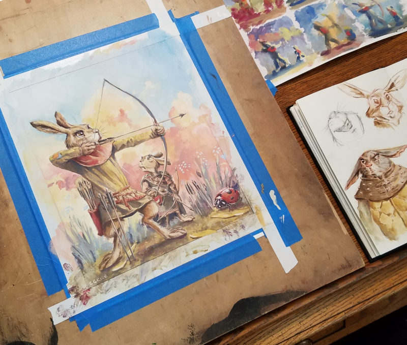 Casein painting by Chuck Grieb of a rabbit fairy teaching his son to shoot an arrow. On the drawing board.