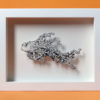 Daria Aksenova. Hand-cut illustration of a space cloud shaped like a fish suspended in a shadowbox structure.