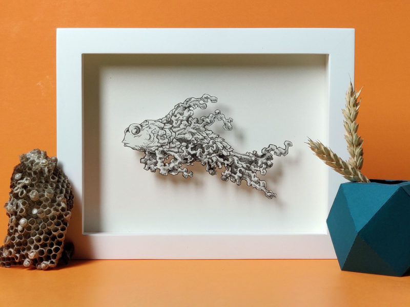 Daria Aksenova. Hand-cut illustration of a space cloud shaped like a fish suspended in a shadowbox structure.