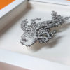 Daria Aksenova. Hand-cut illustration of a space cloud shaped like a fish suspended in a shadowbox structure.