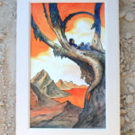 Framed painting of a orange and blue landscape with a person laying on the branches of a tree leaning to the right. There are mountains and a white cloud on the back. The painting stands on a sand floor,
