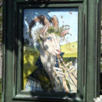 Framed watercolor painting among flowring branches