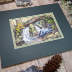 Watercolor painting of blue dragon crossing a small waterfall in the forest