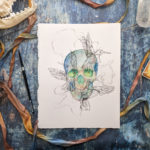 This is an image of a blue watercolor skull painting that has glowing green eyes. The skull is a darker blue around the edges and gradually gets lighter and warmer around the eye sockets and nasal cavity, with a rusty orange mixing in the cooler colors. The is an overlay of three ink hummingbirds drawn in a scribbly fashion directly over the skull. The hummingbirds are connected with tangled ink linework that guides the eye around the piece.