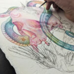 A watercolor painting of a rainbow snake wrapping around a human skull. There are sketchy ink humming birds overlaying the painting.