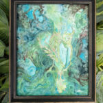 green deer watercolor framed and displayed on hosta leaves.