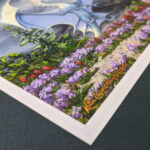 Photo showing the corner of the artwork. The artist's signature is gold and metallic.