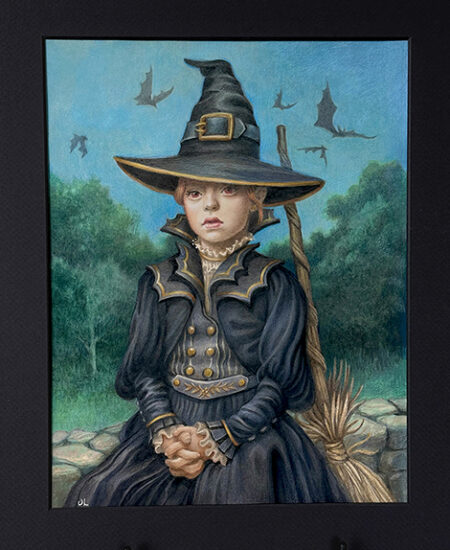 A little girl dressed as a witch sitting on a stone fence