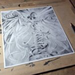Image of graphite drawing on desk with pencils