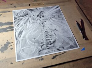 Image of graphite drawing on desk with pencils