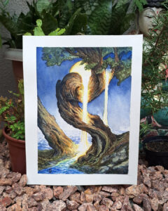 Tree with a golden waterfall and a golden moon behind. There is a stream of water underneath the tree. The painting is standing in front of some plants and a rocky ground.