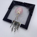 Pink iridescent ribcage holding white heart with gold veins, dripping gold blood