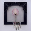 Pink iridescent ribcage holding white heart with gold veins, dripping gold blood