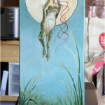 Green frog holding onto a bunch of balloons flying away from his lily pad