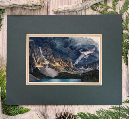 Flat scan view of a white dragon flying over a lake similar to Moraine Lake in Banff, Canada. A dark storm rises from behind the mountains, lit in a blazed line across the center from the setting sun. Image shows the artwork in the mat, a tawny brown inner mat and a forest green top mat.