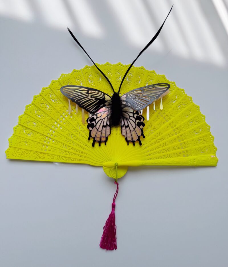 Pink iridescent moth on neon vintage fan