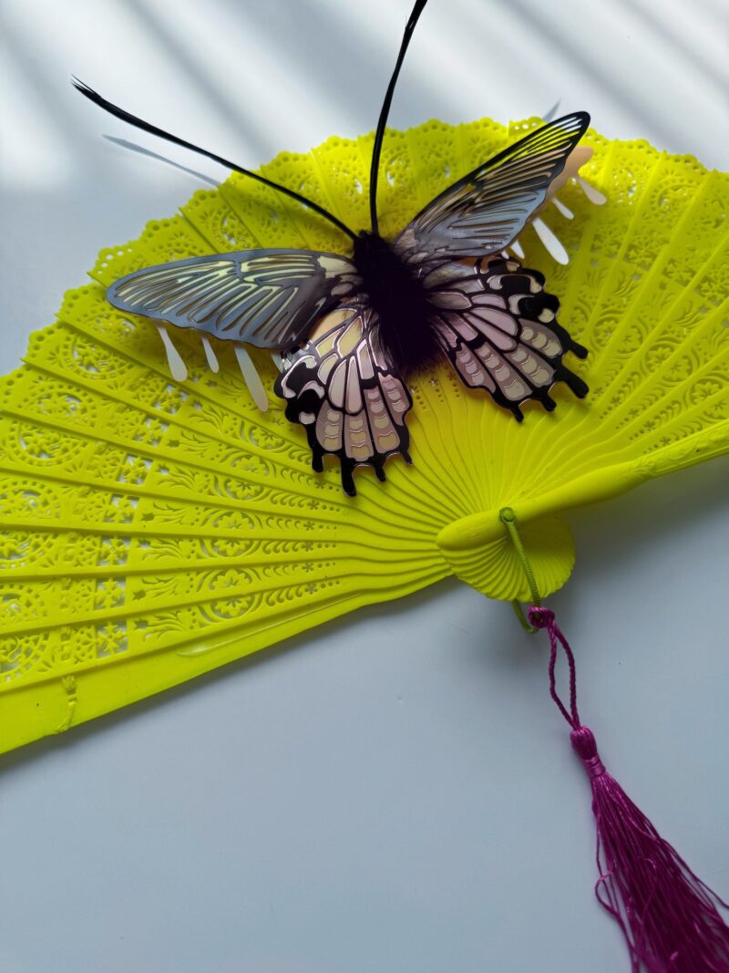 Pink iridescent moth on neon vintage fan