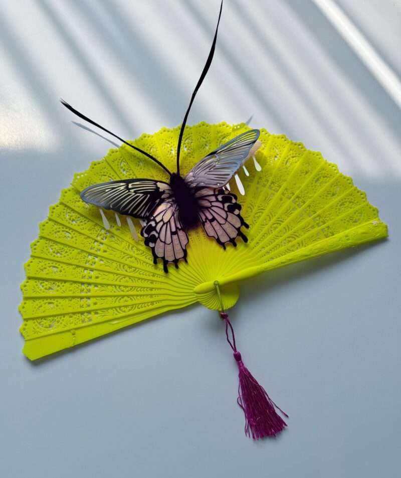 Pink iridescent moth on neon vintage fan