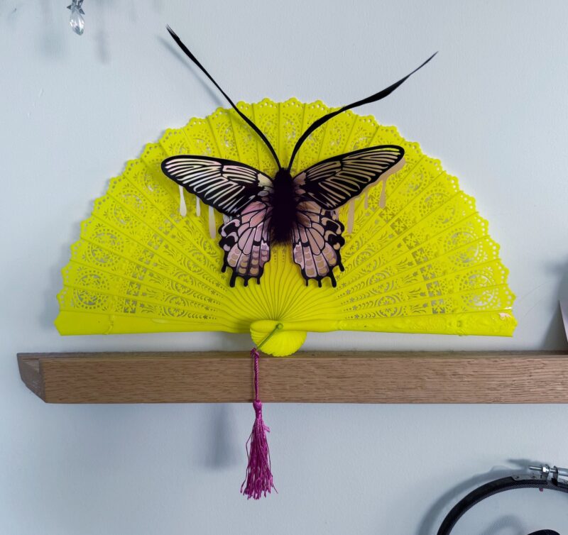 Pink iridescent moth on neon vintage fan