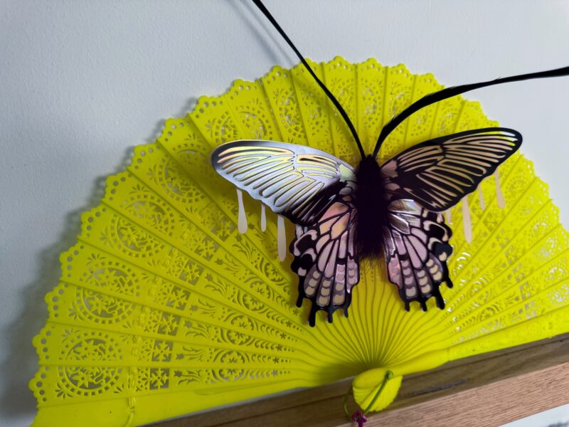 Pink iridescent moth on neon vintage fan