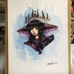 colorful portrait of woman wearing a head dress with two cone shaped pieces on each side of her head.