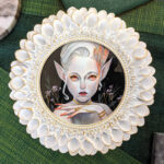 Painting of a fae-like being with orange eyes and nails on a black background