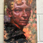 Mixed media portrait of a variant of Hellboy, but with a Tilda Swinton influence on a wall.