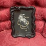 "Sigil II" is framed in a snake frame that can either be free standing or hung on the wall.