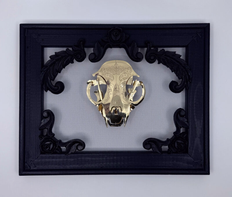 Golden filigree cat skull created with layers of etched and shaped sequin film