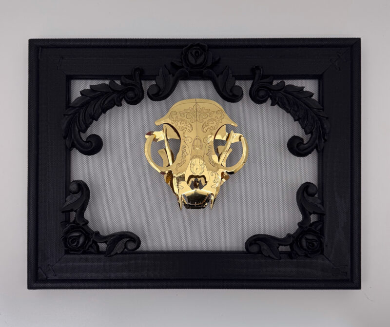 Golden filigree cat skull created with layers of etched and shaped sequin film