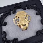 Golden filigree cat skull created with layers of etched and shaped sequin film
