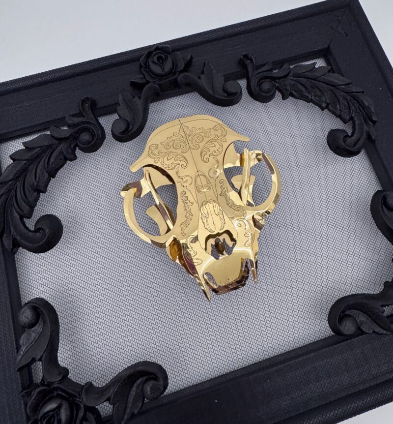 Golden filigree cat skull created with layers of etched and shaped sequin film