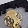Golden filigree cat skull created with layers of etched and shaped sequin film