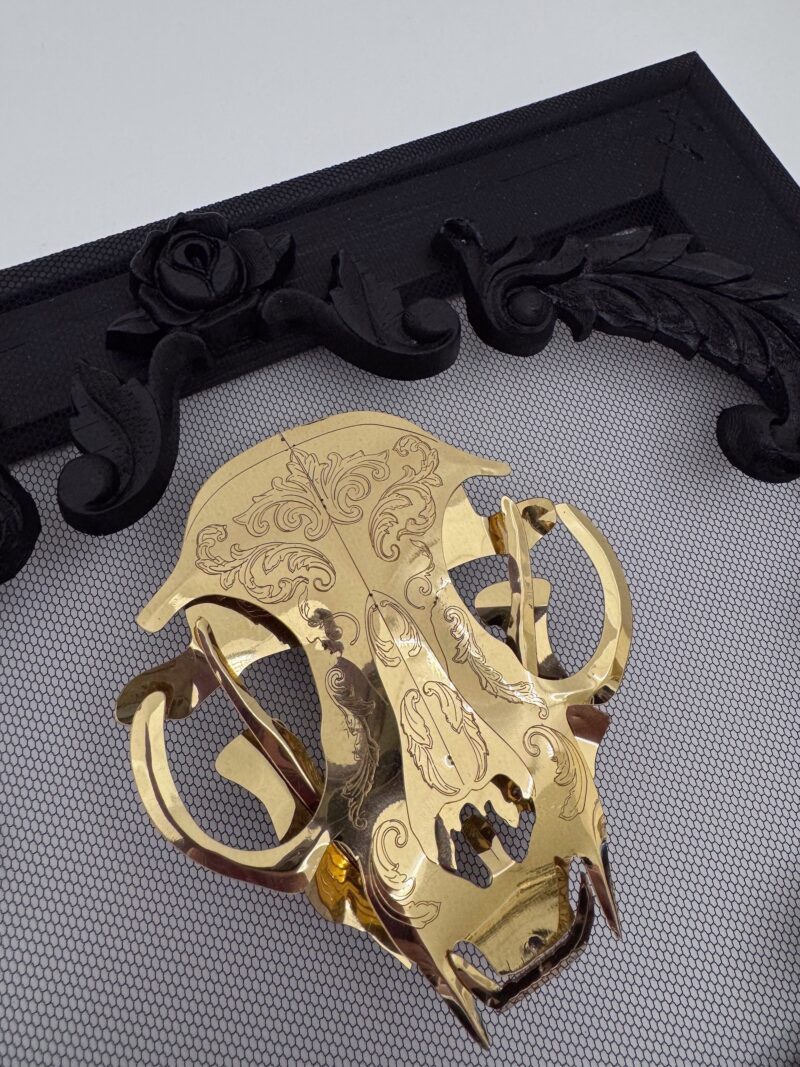 Golden filigree cat skull created with layers of etched and shaped sequin film