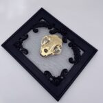 Golden filigree cat skull created with layers of etched and shaped sequin film