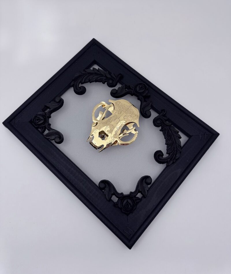 Golden filigree cat skull created with layers of etched and shaped sequin film