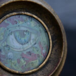 A photo showing the raindrop texture of the glass on the painting