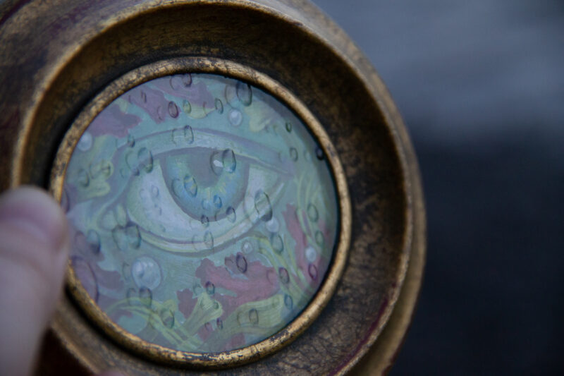 A photo showing the raindrop texture of the glass on the painting