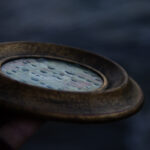 A photo showing the raindrop texture of the glass on the painting