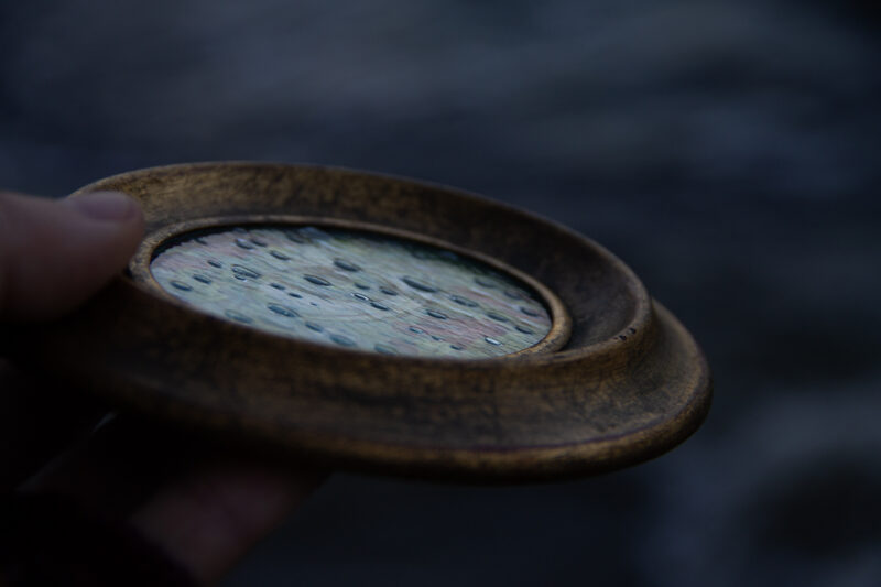 A photo showing the raindrop texture of the glass on the painting