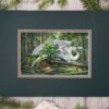 The matted painting sitting on a table with pine cones and wood sticks. A white dragon laying on fallen trees in the forest.