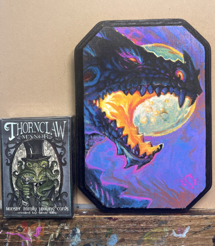 an image of the roaring black dragon with a deck of cards for size comparison.