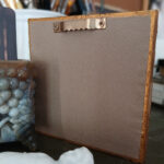 Backside of art depicting a flying tooth, in mixed media