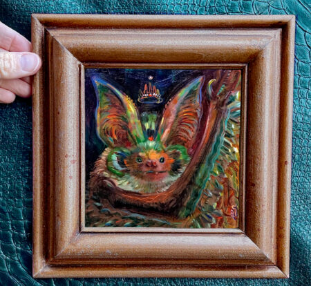A brightly colored painting of a bat framed for display