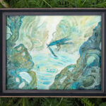 framed watercolor painting of a blue raven, set on top of outside grass.