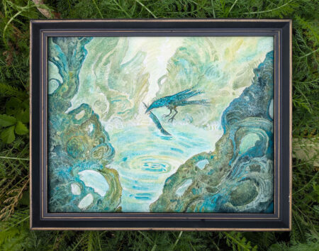 framed watercolor painting of a blue raven, set on top of outside grass.